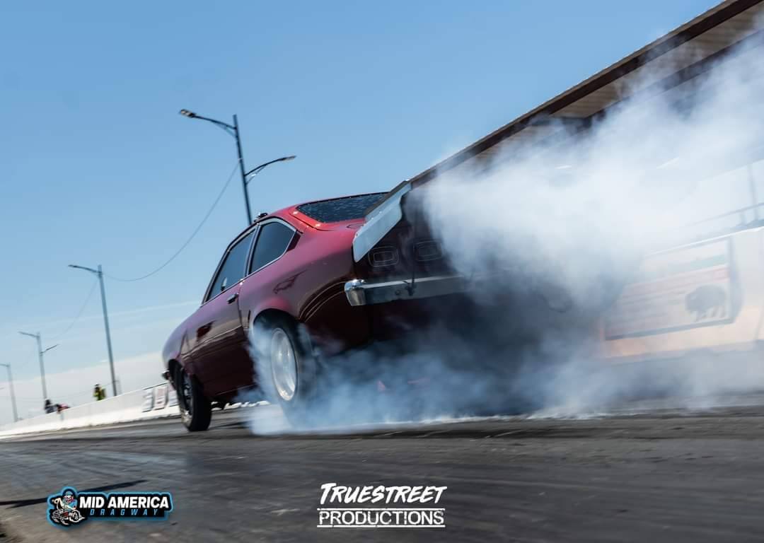 Red race car making tire smoke